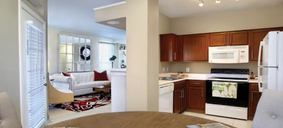 Spacious luxury apartments with built-in shelves, spacious dining room, u-shaped kitchen, rich brown toned cabinets, crown molding, French door and oversized windows at The Biltmore Apartments in Omaha, Nebraska