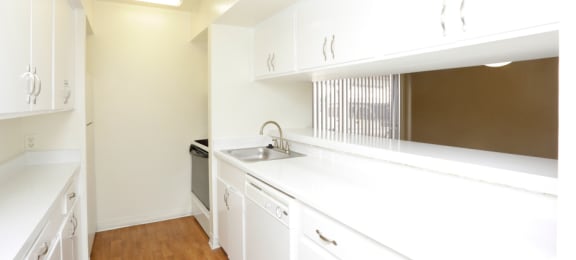 Apartments near the Galleria with bright white kitchens, wood plank floors, and extra cabinet space