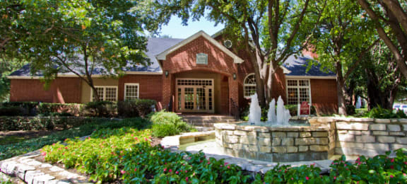 Luxury apartments in north Dallas with beautiful landscaping, scenic views, and red brick exteriors at PrestonVillage Apartments