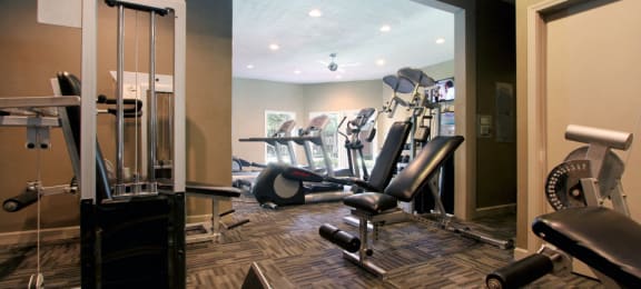 Luxury apartments with a fitness center in a gated community at Preston Village Apartments in North Dallas
