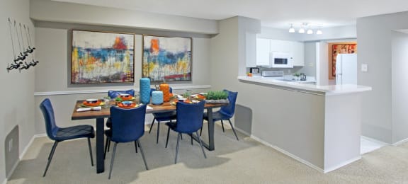 Spacious apartments with dining room and kitchen with white cabinets at Preston Village Apartments in north Dallas