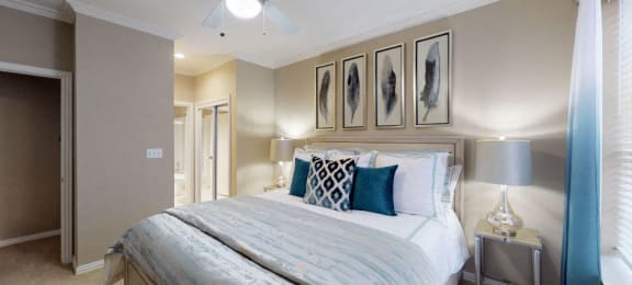 Luxury apartments with spacious bedrooms, walk-in closets, and ceiling fans at Tuscany Gate Apartments in Houston.