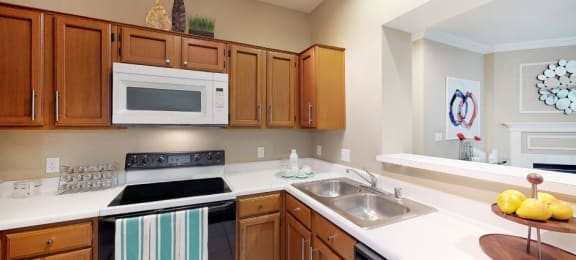 Luxury apartments with spacious kitchens, custom home cabinets, and breakfast bars at Tuscany Gate Apartments in Houston.