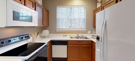 Luxury apartments with spacious kitchens, custom home cabinets, and side-by-side refrigerators at Tuscany Gate Apartments in Houston.