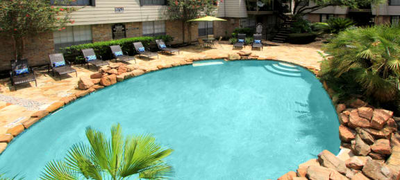 Gated apartment community close to the Galleria with pool, spa, poolside lounge chairs, lush landscaping, beautiful landscaping, and neighborhood setting.