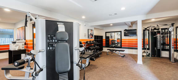 a gym with various machines and chairs in a room