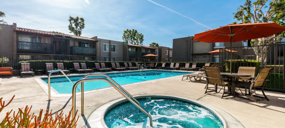 our apartments have a resort style pool with chairs and umbrellas