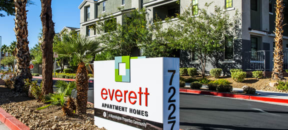 Entry monument sign with building nearby