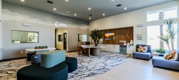 a lobby with couches tables and chairs and a reception desk at SYNC APARTMENT HOMES, North Las Vegas