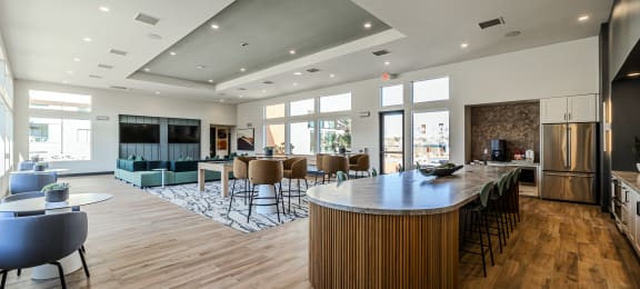 a clubhouse with a bar and a living room with couches at SYNC APARTMENT HOMES, Nevada, 89084