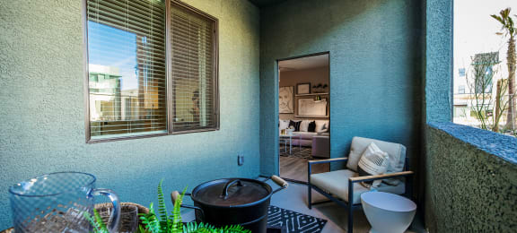 a balcony with a chair and a toilet and a plant at SYNC APARTMENT HOMES, North Las Vegas, NV 89084