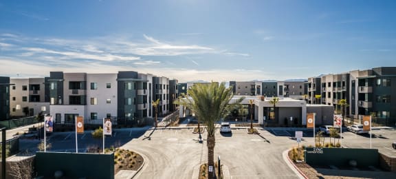 an empty parking lot in front of a row of apartment buildings at SYNC APARTMENT HOMES, Nevada