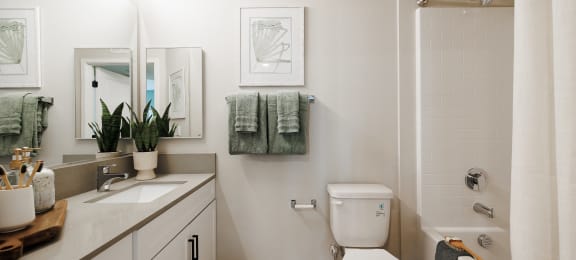 a bathroom with a toilet and a sink and a shower at SYNC APARTMENT HOMES, North Las Vegas, NV