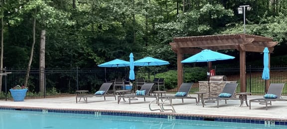 Place at Midway Douglasville GA sparkling swimming pool with chaise lounge chairs and umbrellas