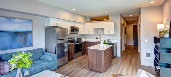Bothell, WA Apartments for Rent - Open-Concept Kitchen with Wood Flooring, Stainless Steel Appliances, and Mobile Island