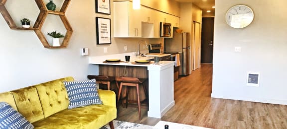 Bothell Apartments for Rent - Spacious Living Room with Wood Flooring, Access to Kitchen, and Modern Furnishings