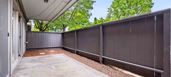 Fremont Apartments for Rent - Logan Park - Huge Patio with Concrete Floor, Wood Chips, and Privacy Fence