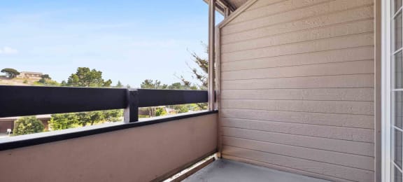 Two-Bedroom Apartments in Daly City, CA - Serra Commons - Patio with Sliding Door, Concrete Floor, and Neighborhood Views