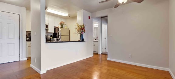 1 And 2 BR Apartments In Daly City, CA - Serra Commons - Kitchen With Grey Countertops, Modern Decor, White Cabinets, And Stainless-Steel Appliances.