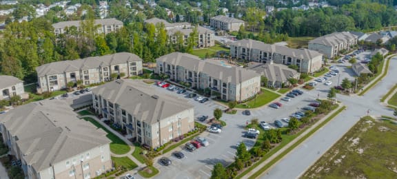 an aerial view of a group of houses in a parking lot