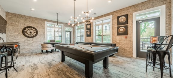 a game room with a pool table and a bar