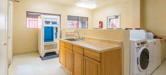 Laundry room with sink and water jug dispenser