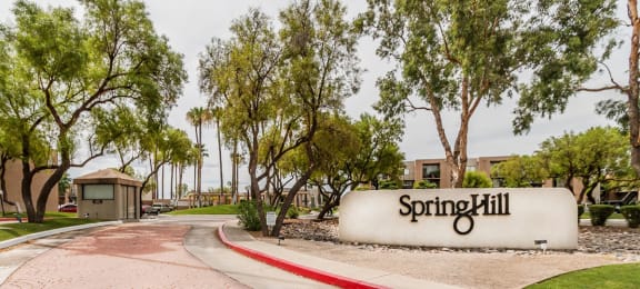 Springhill community sign and entrance with lush landscape throughout
