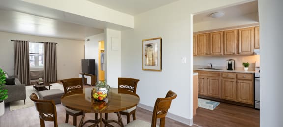 Kitchen With Updated Cabinets and Flooring With Adjacent Dining Room at Georgetowne Homes Apartments, Massachusetts