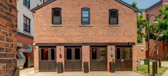 the front of a brick building with three doors at Ninth Square Apartments, New Haven, CT