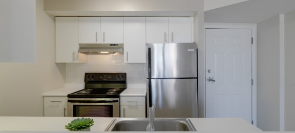 a kitchen with white counters and a stainless steel refrigerator at Ninth Square Apartments, New Haven, CT