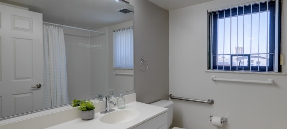 a bathroom with a sink and a toilet and a mirror at Ninth Square Apartments, Connecticut, 06510