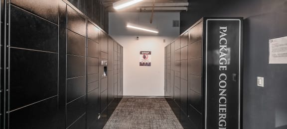 a hallway with black lockers and a welcome sign at Ninth Square Apartments, New Haven, CT, 06510