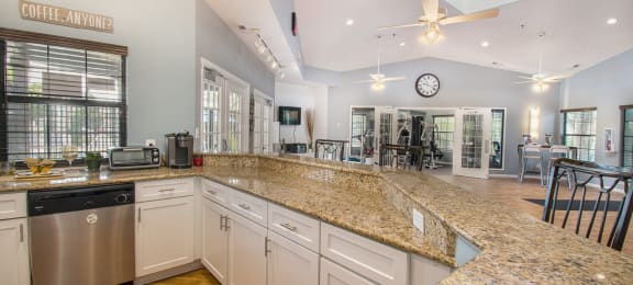 a large kitchen with granite countertops and stainless steel appliances