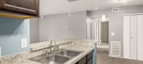 a kitchen with granite countertops and a sink