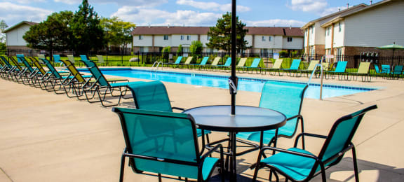 our apartments have a resort style pool with chairs and tables