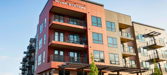 a tall building with a sign that reads river station