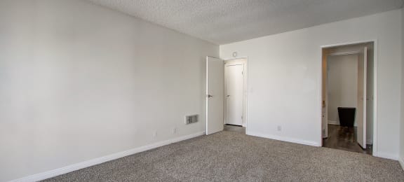 a bedroom with a carpeted floor and white walls