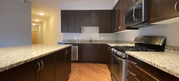 a kitchen with a stove top oven and a microwave