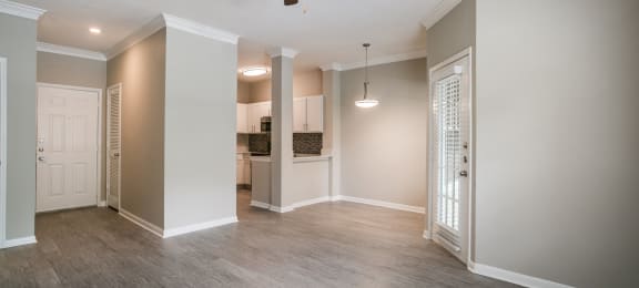 Dog Friendly Apartments in Houston TX - The Maroneal - Open-Concept Living Room with Access to the Kitchen, Hardwood Flooring, and Ceiling Fan
