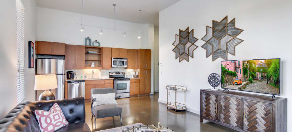 12 South Nashville TN apartments a living room with a leather couch and a flat screen tv