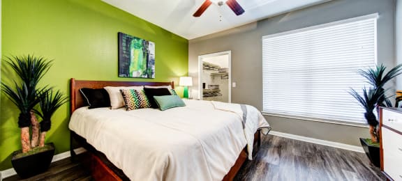 bedroom with large window and ceiling fan