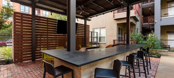 Patio with a bar and chairs  at The Can Plant Residences at Pearl, Texas