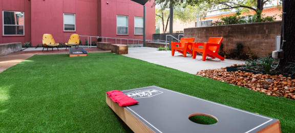 Outdoor Yard with a ping pong table and grass at The Can Plant Residences at Pearl, San Antonio, TX 78215and a white counter top  at The Can Plant Residences at Pearl, San Antonio, 78215