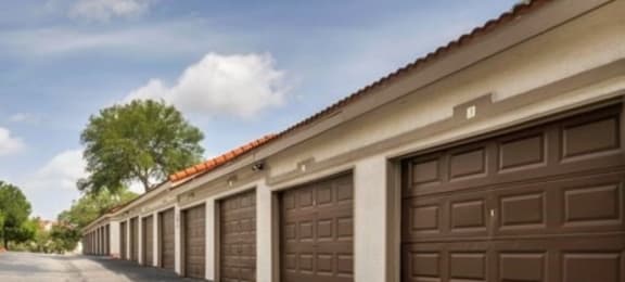 a row of garages with brown doors