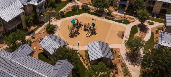 an aerial view of a playground in the courtyard of an apartment complex