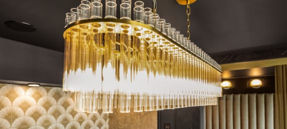 a chandelier made of champagne glasses hangs from the ceiling