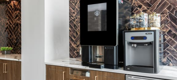 a kitchen with a coffee machine and a refrigerator