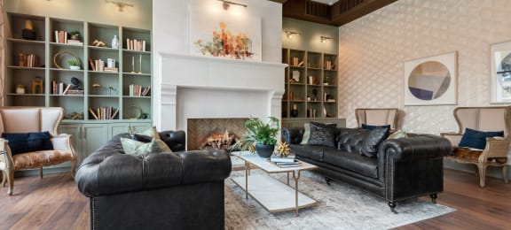 a living room with two leather couches and a fireplace