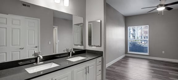 a bathroom with a large mirror and a window
