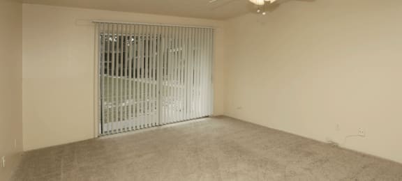 Carpeted living room with doorwall